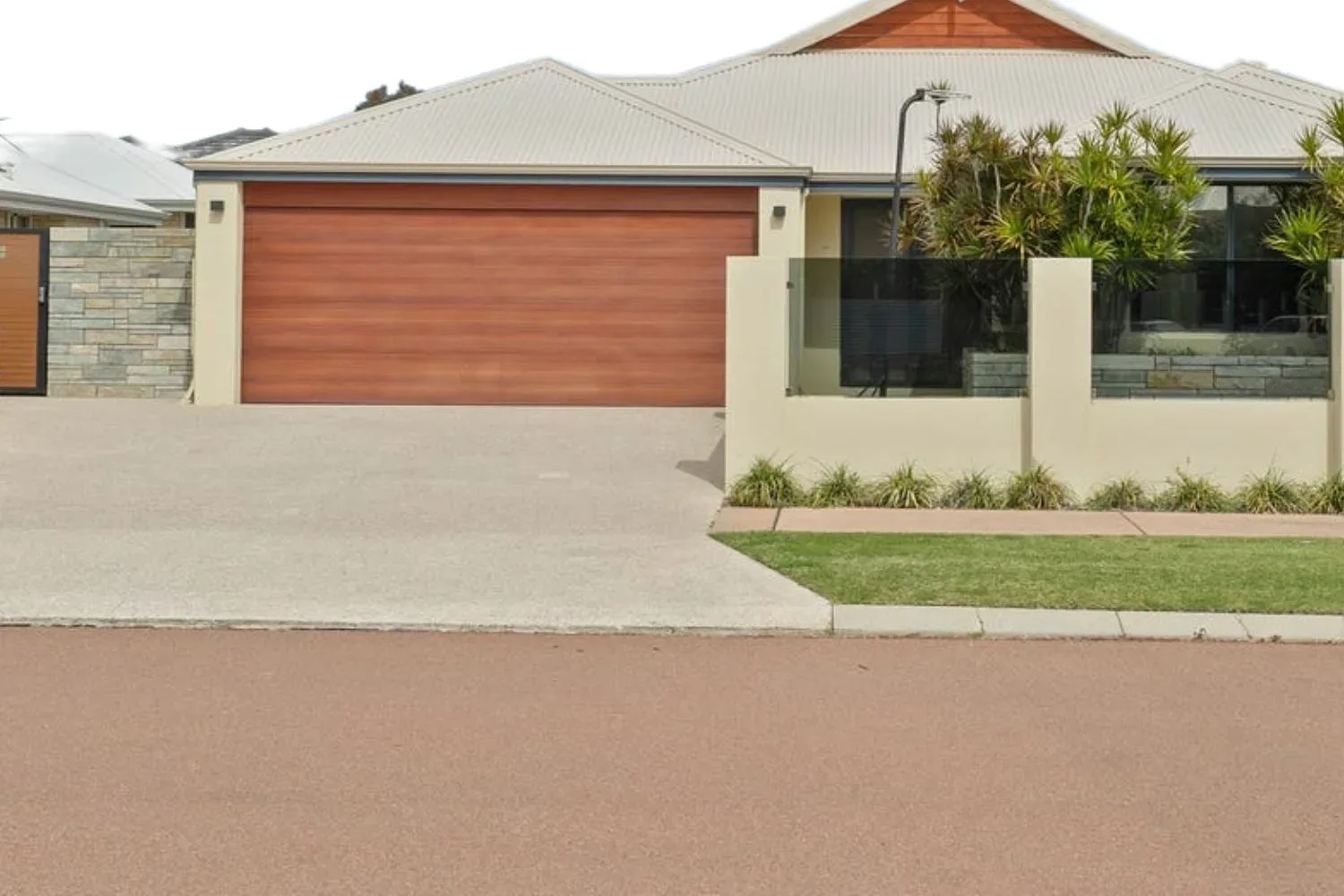 Finished concrete driveway crossover connecting a home to the street