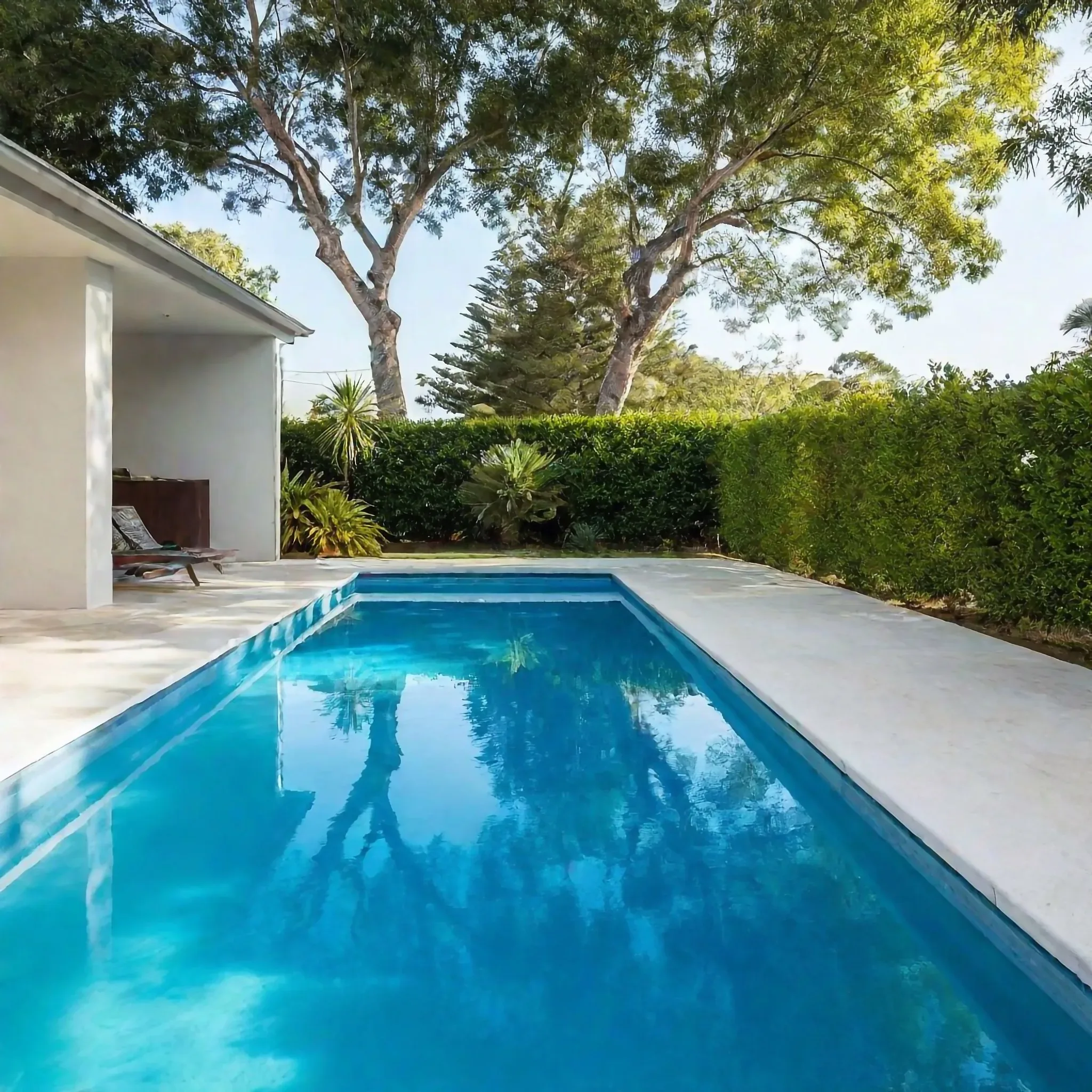 Non-slip concrete pool surround around a backyard pool