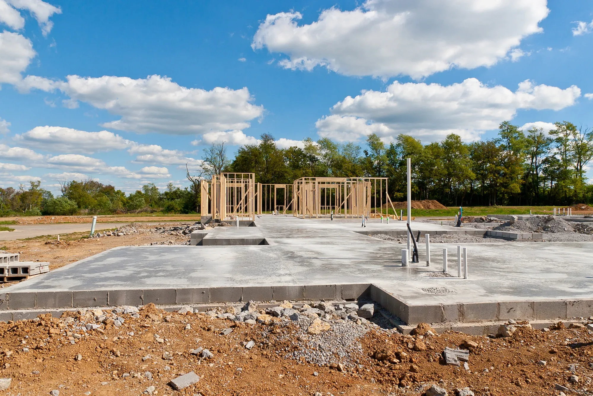 A new concrete slab foundation poured and ready for framing on a residential build